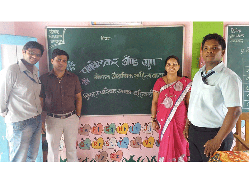 1 woman and 3 men are standing in school